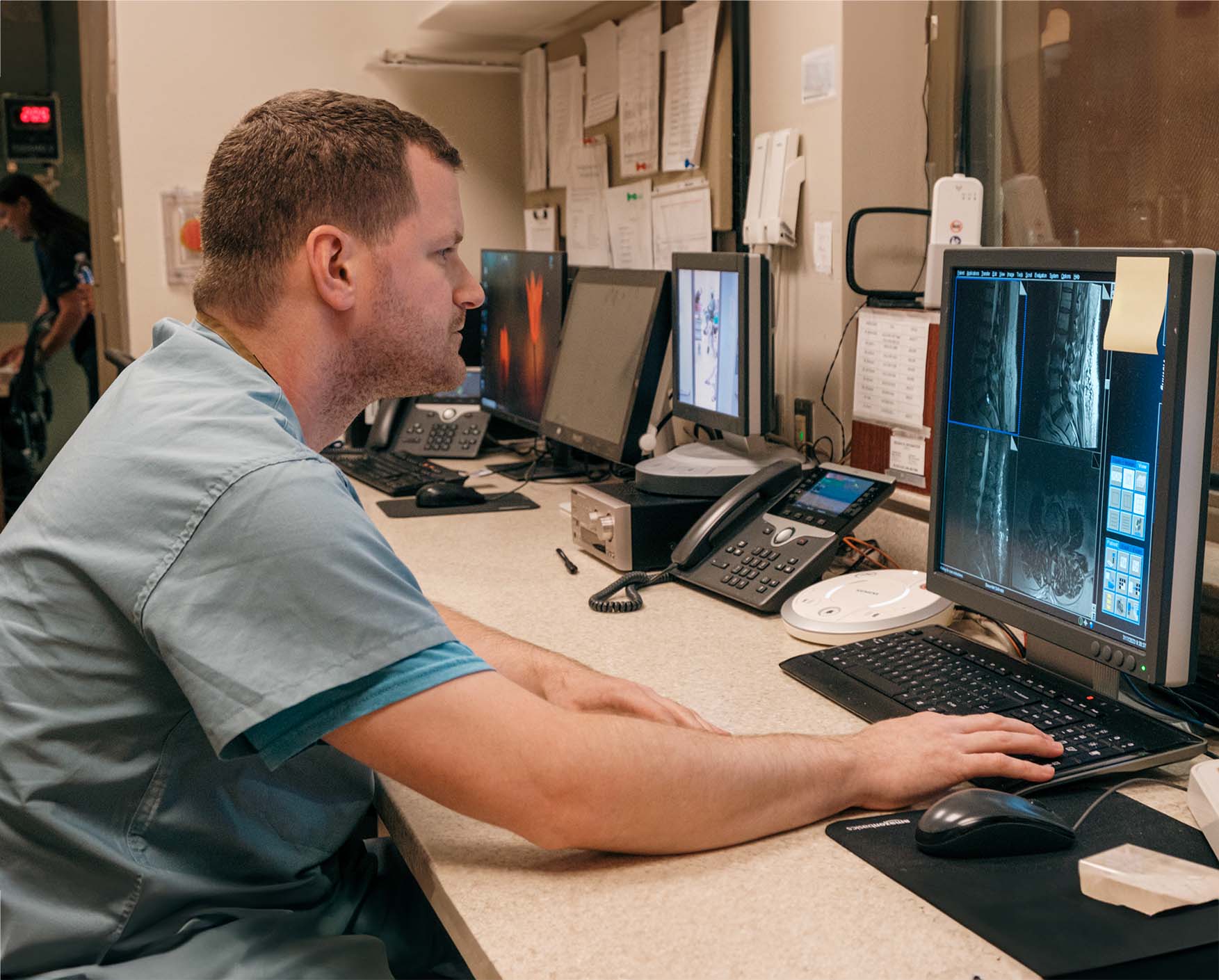 Radiologist using a Picture Archiving and Communication System to review medical images.