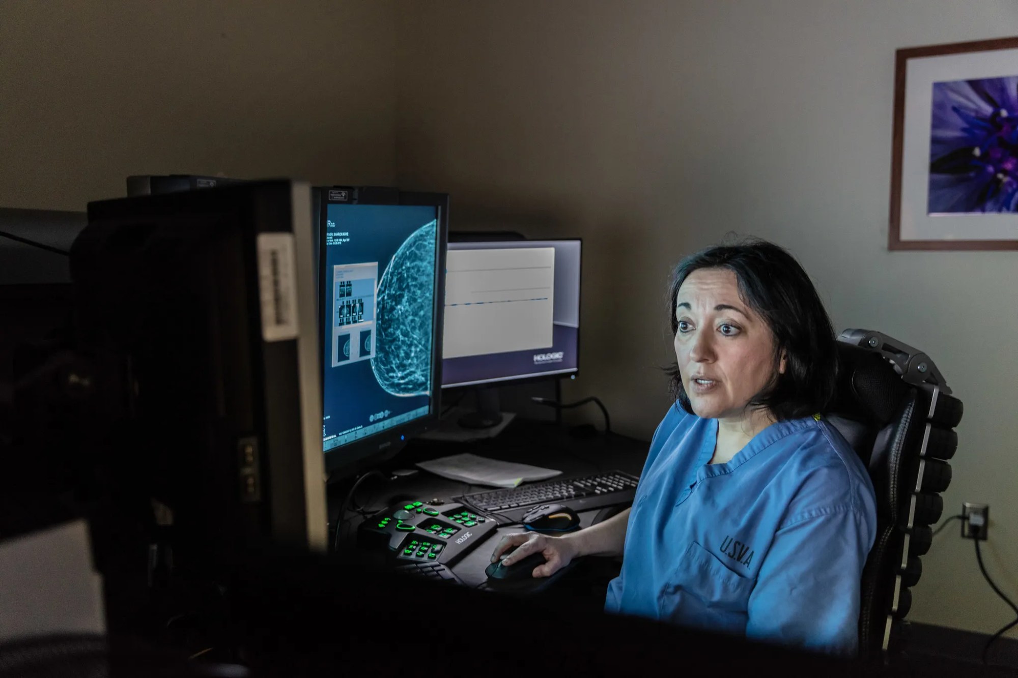 Female doctor sitting at ther desk on her computer