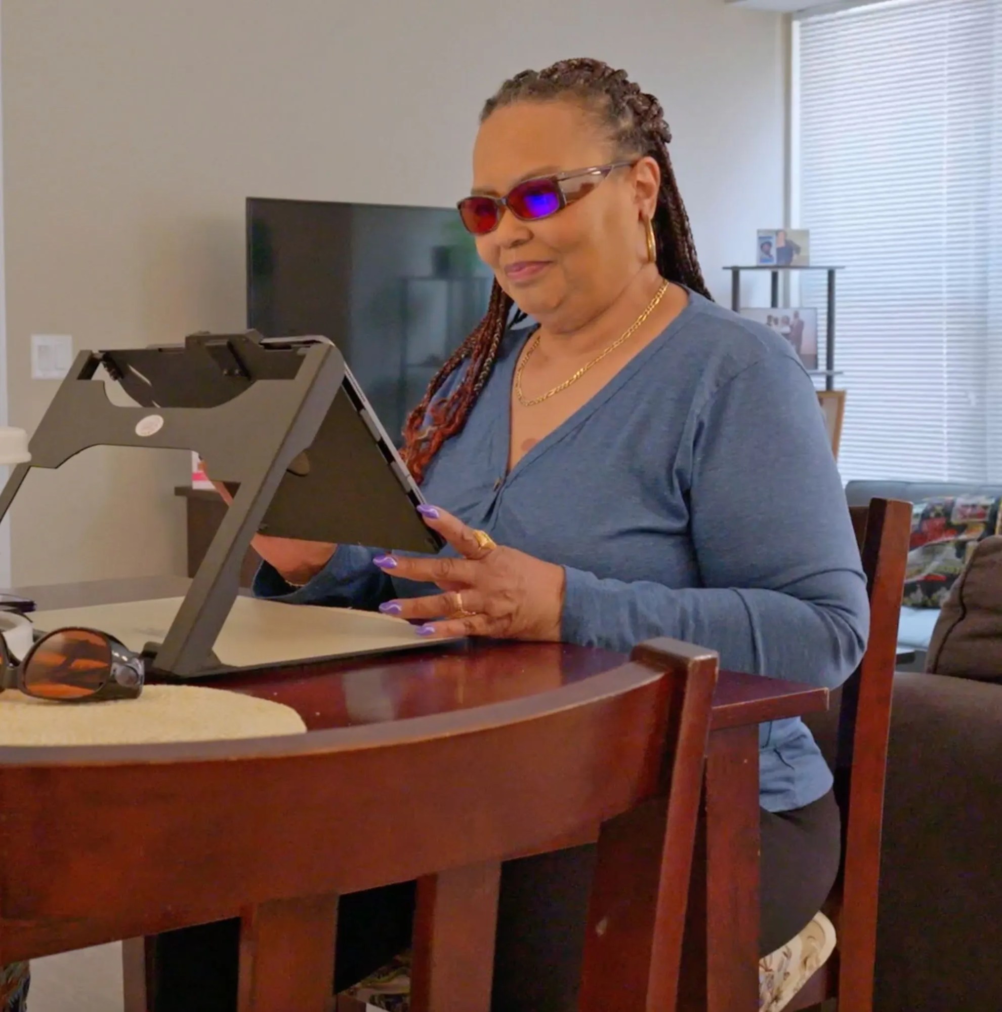 Woman sitting at a table on her iPad