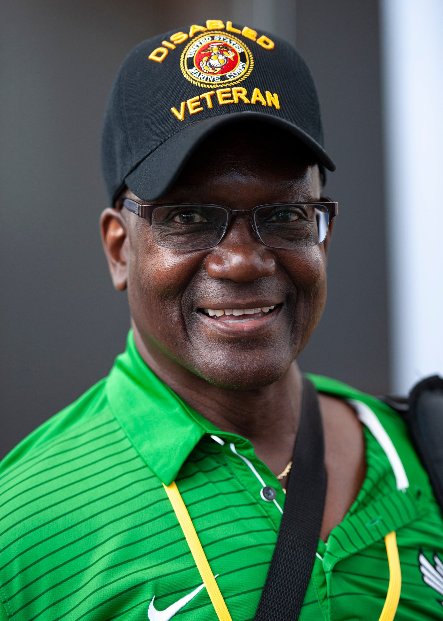 Marine veteran smiliing at the camera wearing a Disabled Veteran hat