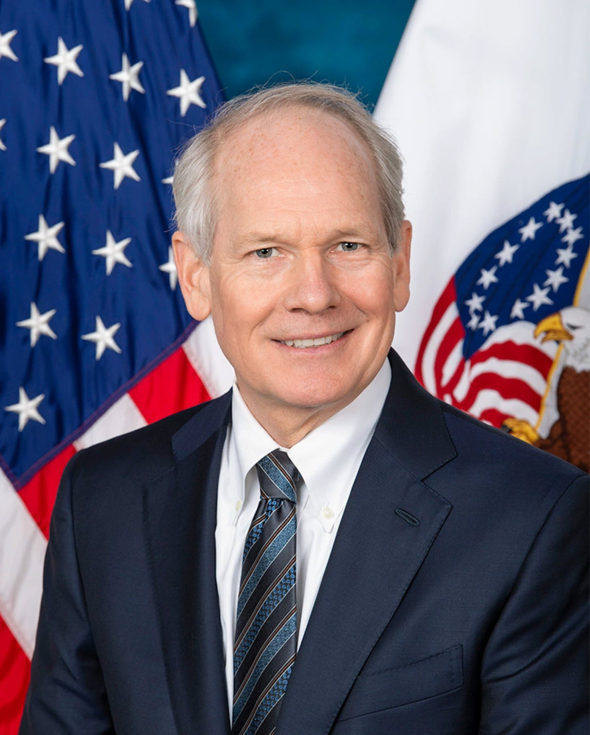 Kurt DelBene with the US and VA flag in the background